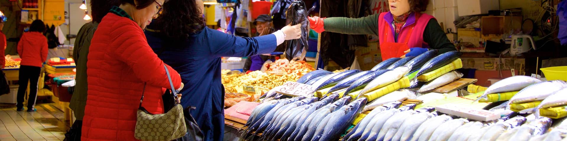 Incheon featuring markets and food as well as a small group of people