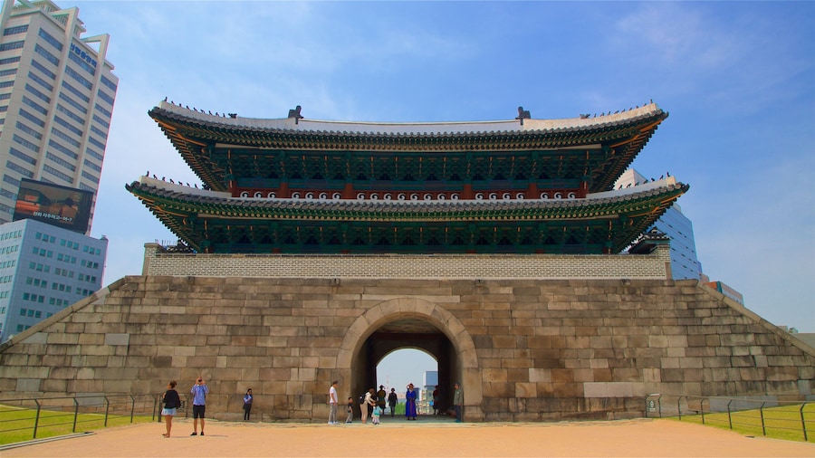 Sungnyemun Gate showing heritage architecture as well as a small group of people