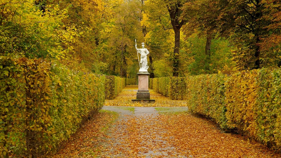 Exploring the autumnal gardens of Schloss Charlottenburg in Berlin surrounded by vibrant foliage
