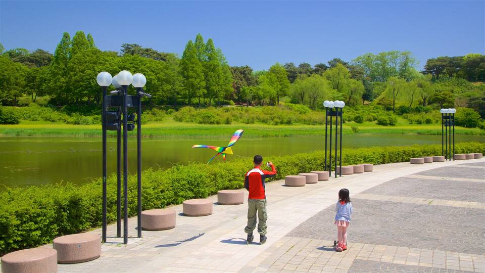 Olympic Park featuring a river or creek as well as a family
