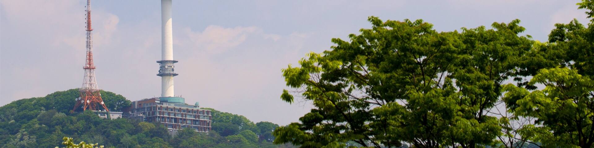 N Seoul Tower showing a high-rise building and a sunset