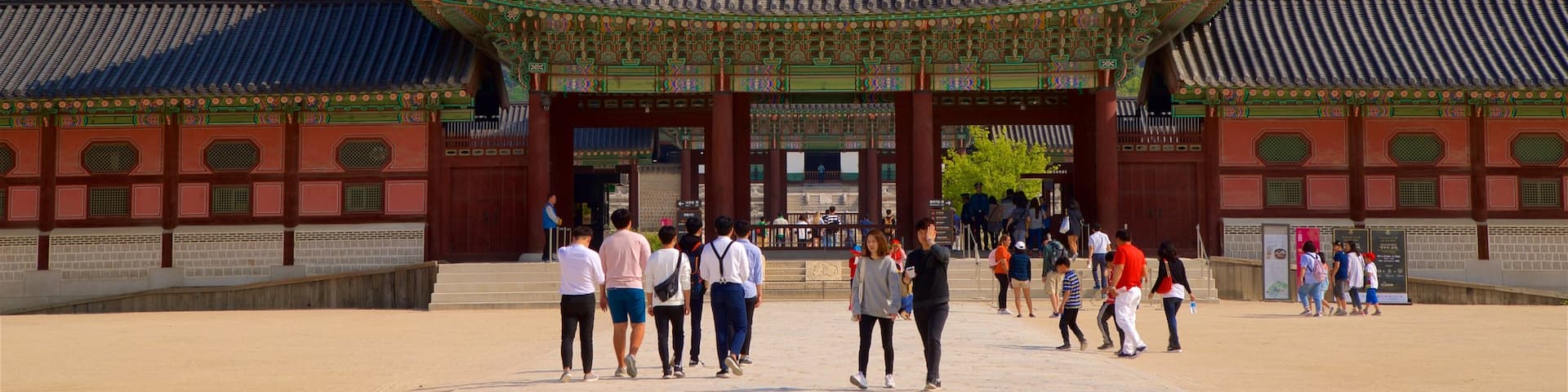 Gyeongbok Palace showing a square or plaza and heritage architecture as well as a small group of people