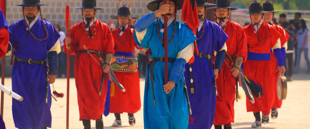 Gyeongbok Palace showing performance art as well as a small group of people