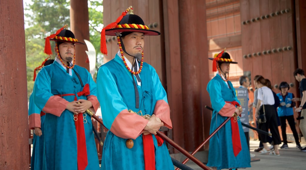 Deoksugung Palace showing performance art as well as a small group of people