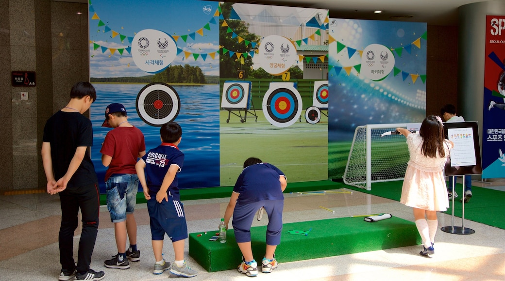 Seoul Olympic Museum featuring signage and interior views as well as a small group of people