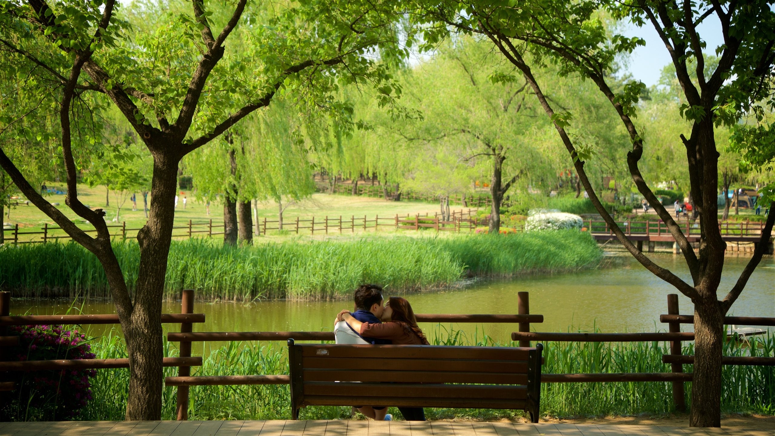 Yongsan Park featuring a pond and a garden as well as a couple