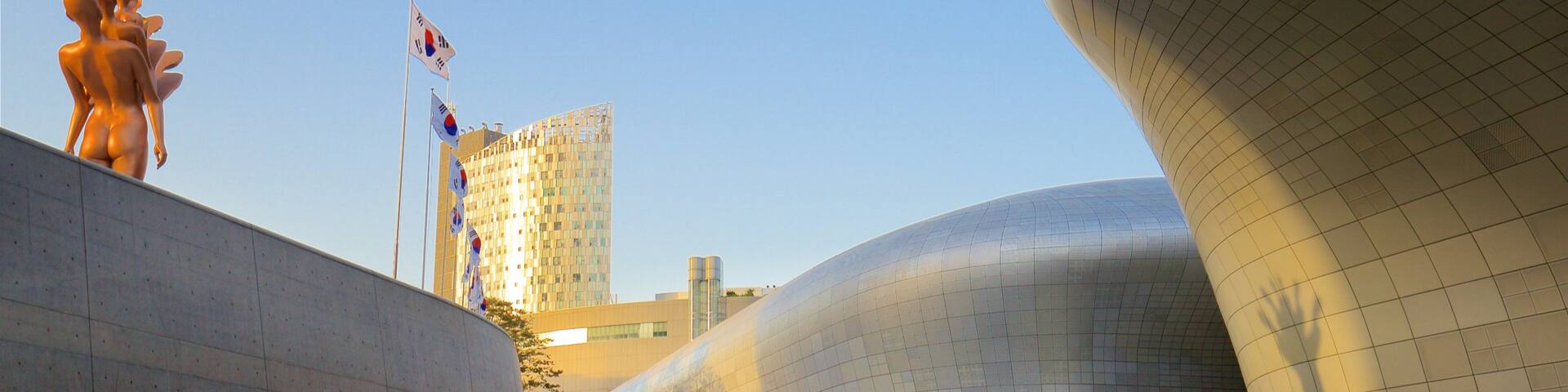 Dongdaemun Design Plaza showing outdoor art, a sunset and modern architecture