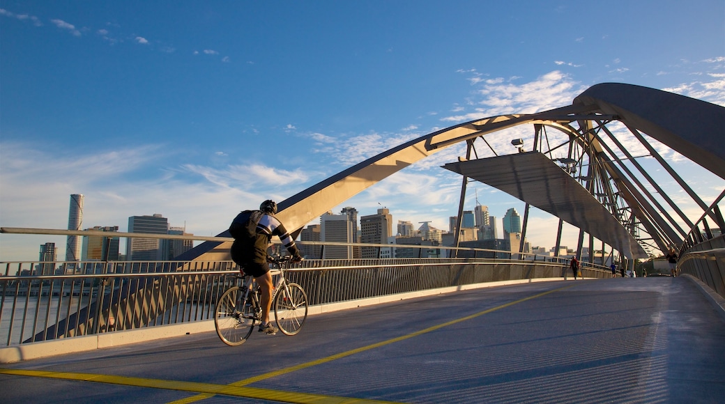Southbank Parklands som visar en solnedgång, en stad och cykling