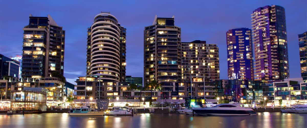 Docklands which includes a bay or harbour, night scenes and a high-rise building