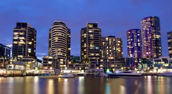 Docklands which includes a bay or harbour, night scenes and a high-rise building