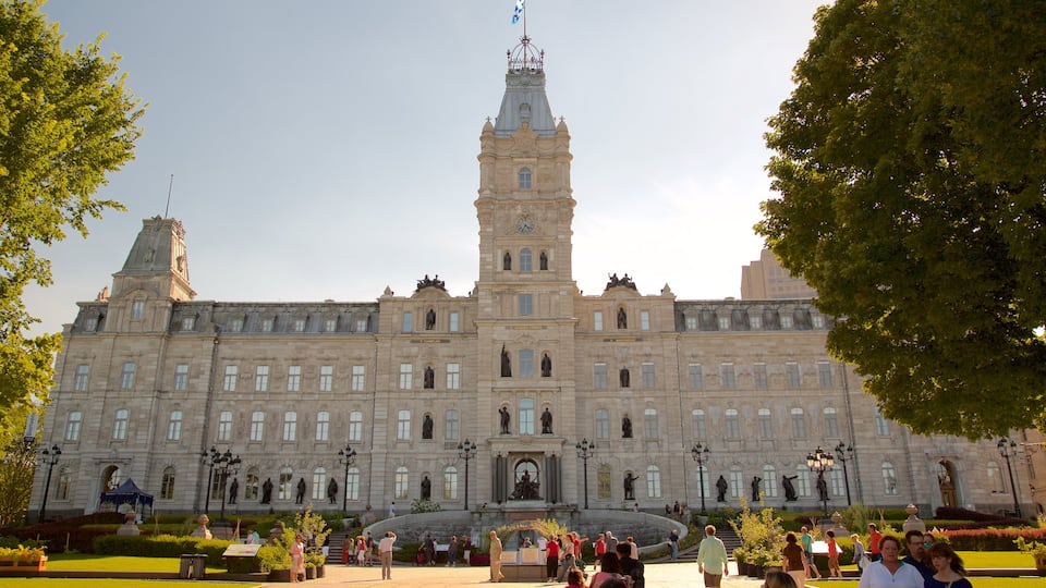 Parliament Building which includes heritage architecture and a sunset as well as a small group of people