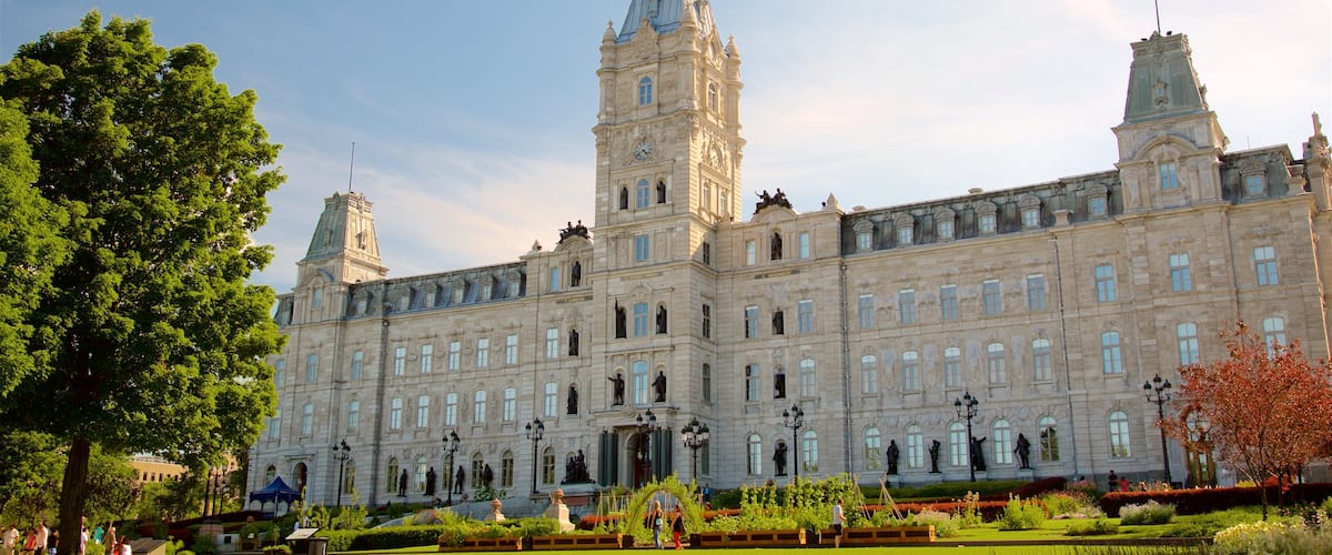 Parliament Building which includes a park, a sunset and heritage architecture
