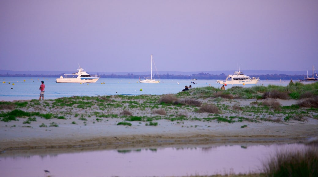 Western Australia featuring a bay or harbor, a sandy beach and a sunset