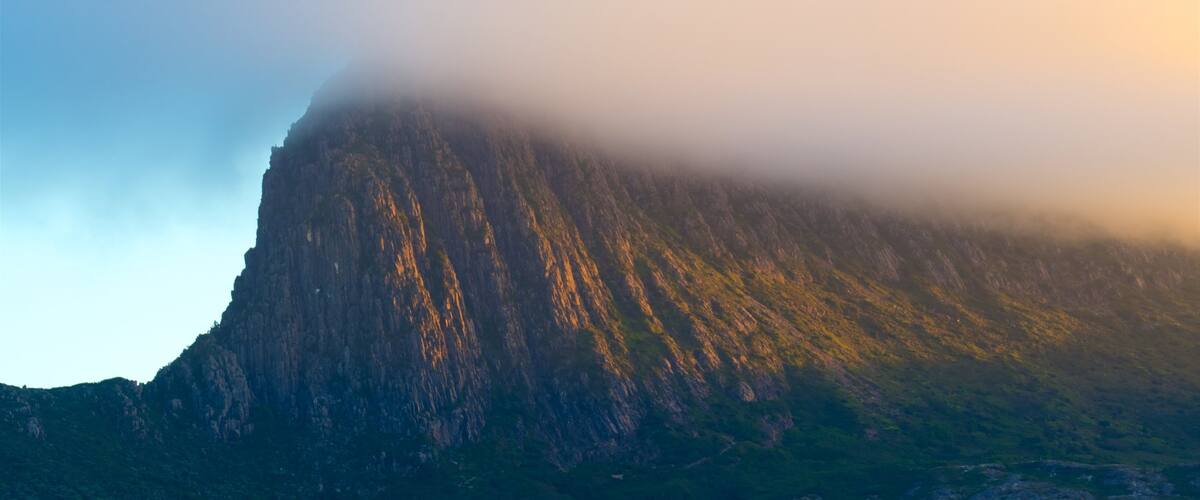 Midlands featuring a sunset, mountains and mist or fog