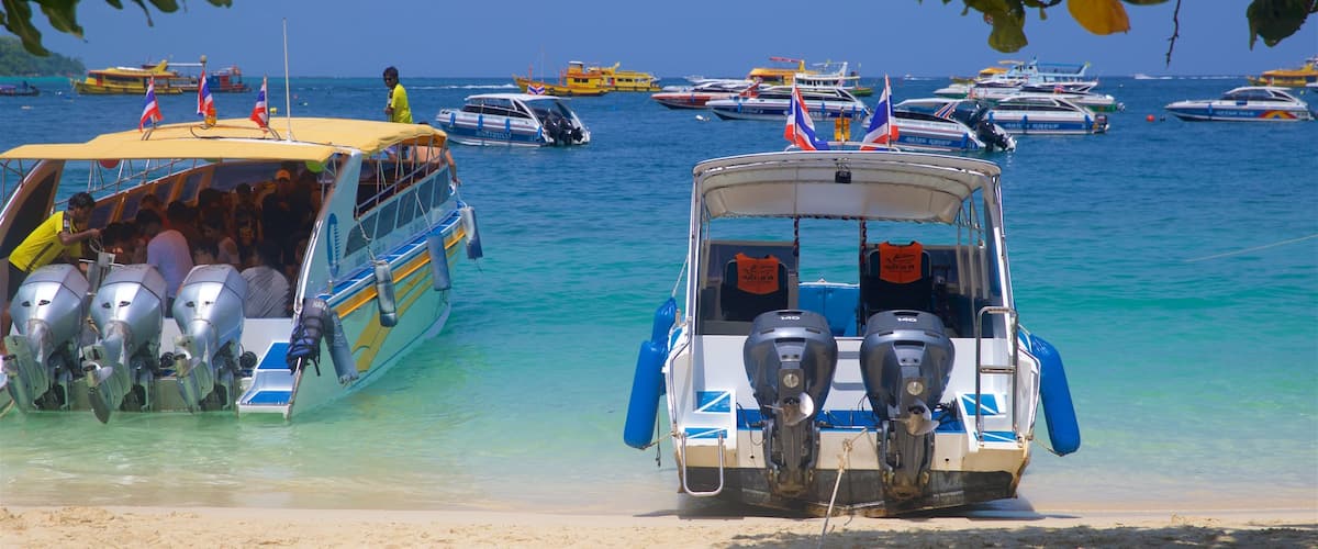Ko Phi Phi which includes tropical scenes, a sandy beach and a bay or harbour