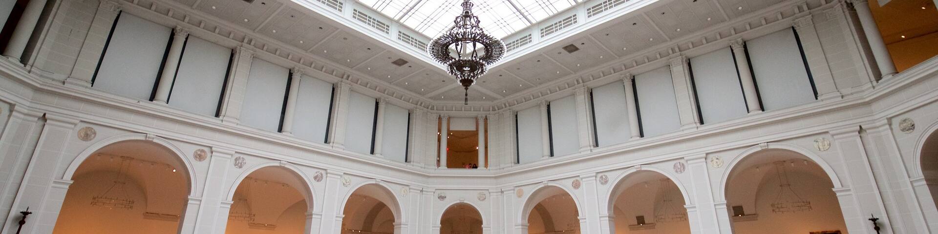 Brooklyn Museum featuring heritage elements and interior views as well as a small group of people