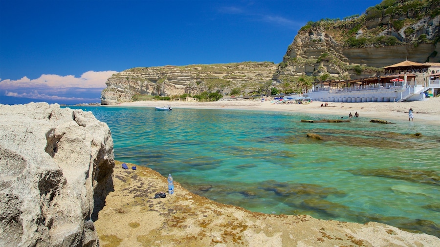 Riaci Beach which includes rocky coastline, general coastal views and tropical scenes