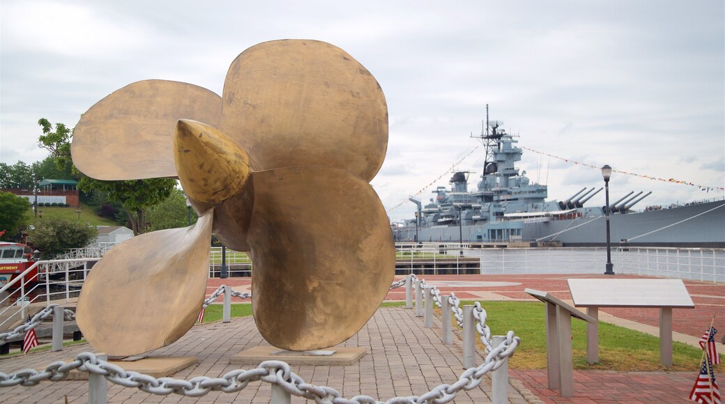 Wiggins Park and Marina showing military items, a marina and outdoor art