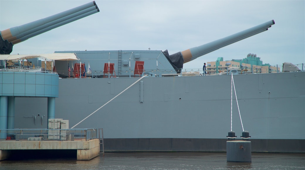 Battleship New Jersey showing military items and a marina