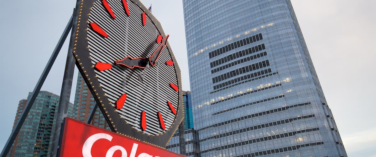 Colgate Clock featuring a city, signage and a high rise building