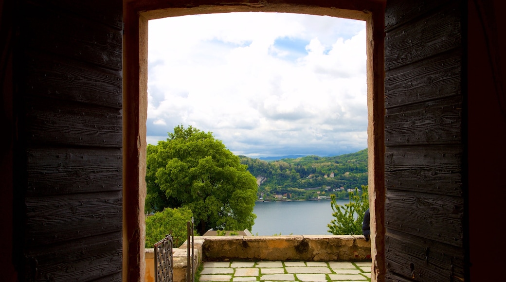 Rocca di Angera which includes a lake or waterhole and interior views