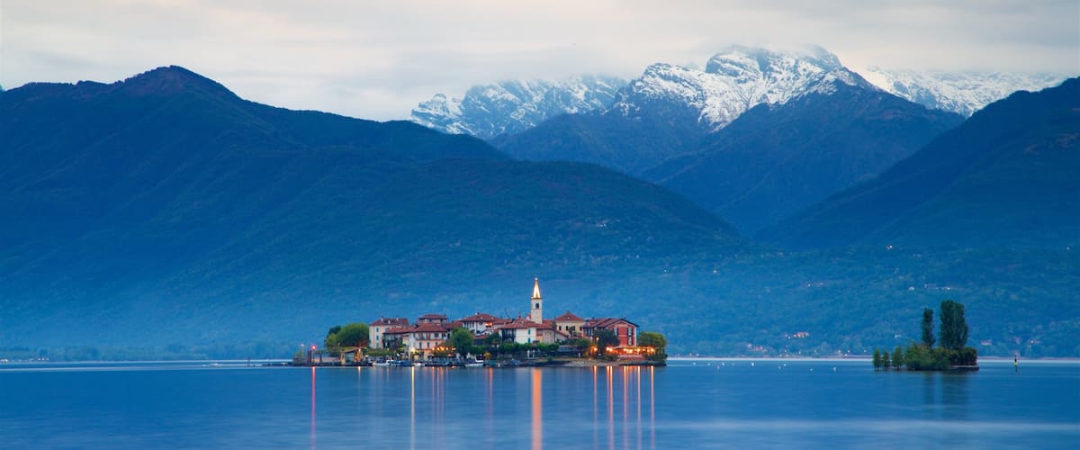 Isola dei Pescatori which includes a lake or waterhole, a small town or village and mountains