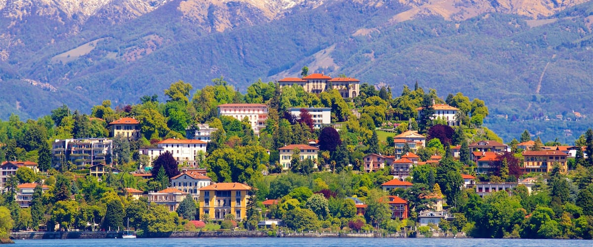 Verbania featuring a small town or village, a lake or waterhole and mountains