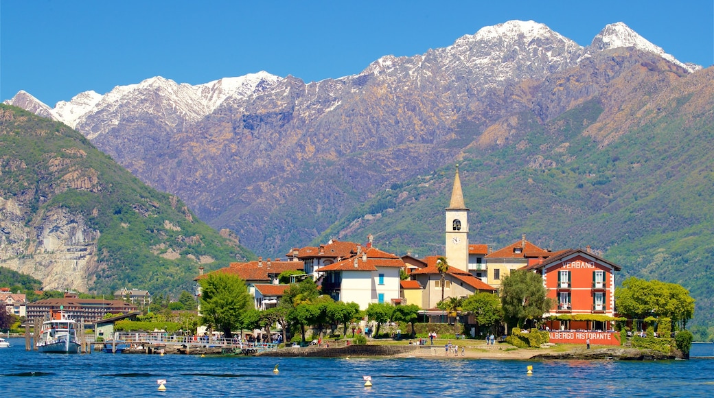 Isola dei Pescatori mostrando un lago o espejo de agua, una pequeña ciudad o aldea y montañas