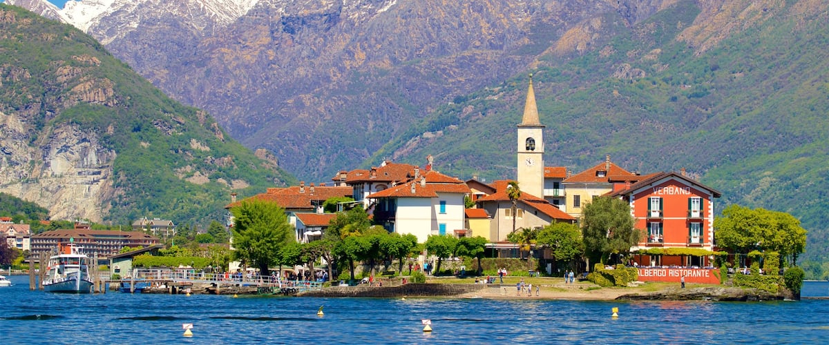 Isola dei Pescatori featuring a small town or village, mountains and a lake or waterhole