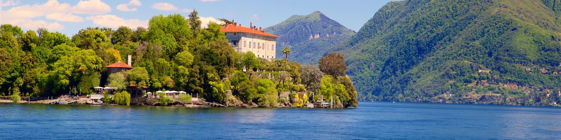 Isola Madre Botanical Garden featuring a small town or village, a lake or waterhole and mountains