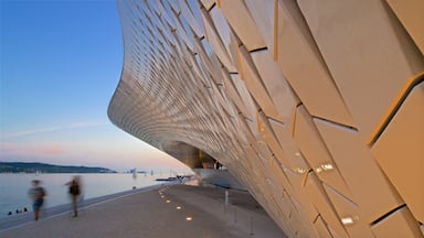 Lisbon District showing a sunset, modern architecture and a bay or harbour