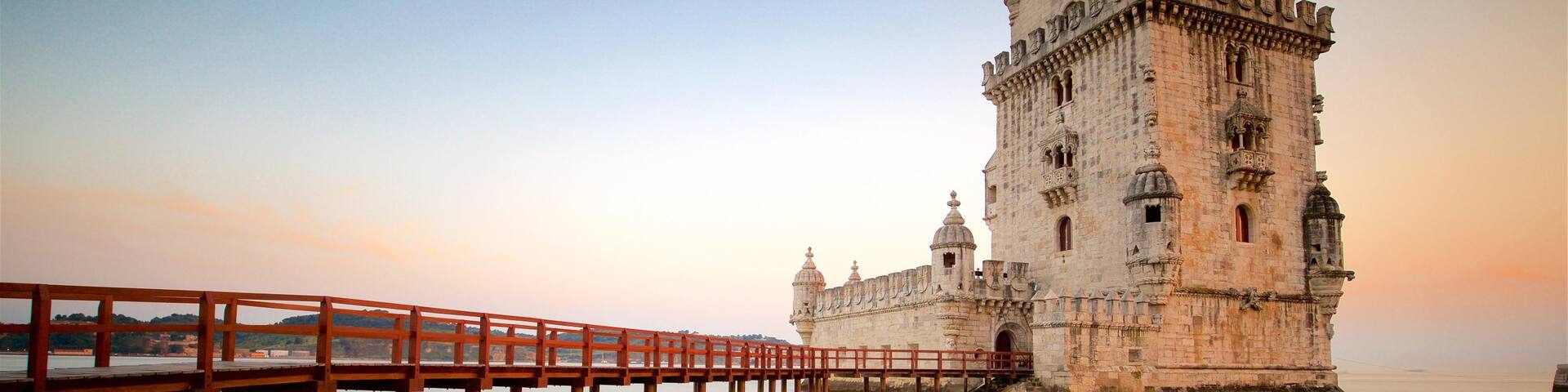 Belem Tower which includes a sunset, heritage architecture and a bridge