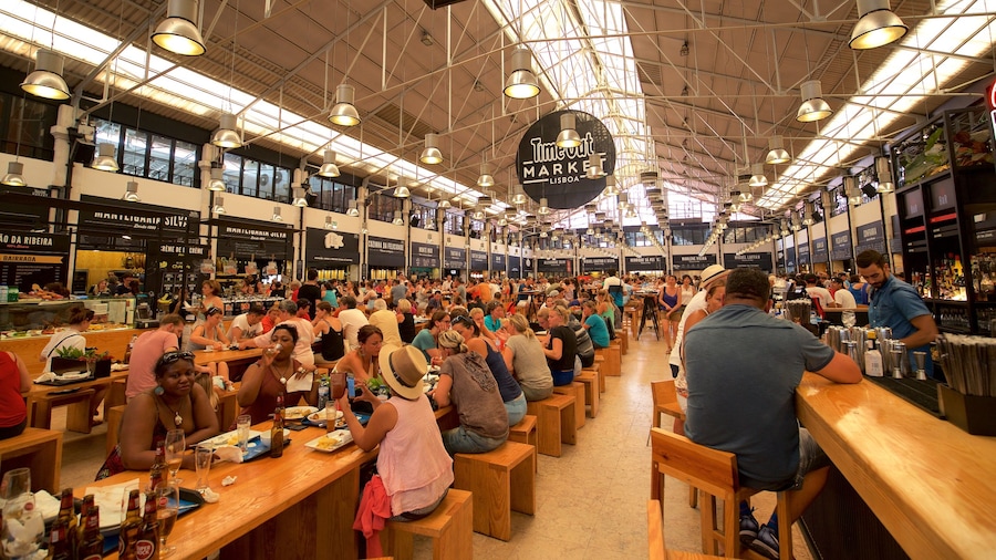 Lisbon District featuring interior views and markets as well as a large group of people