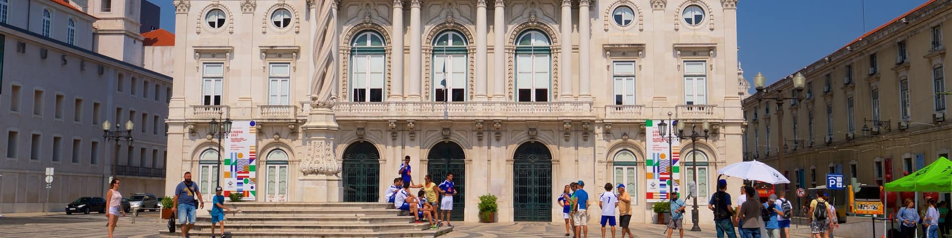 Lisbon District which includes a square or plaza and heritage architecture as well as a small group of people