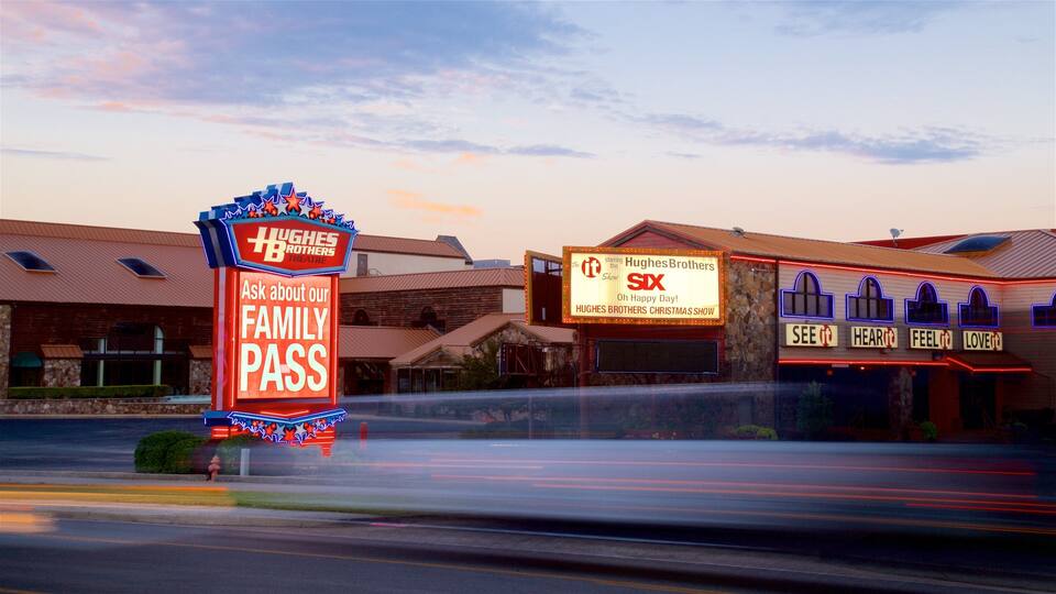 Hughes Brothers Theatre featuring signage and a sunset