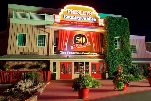 Presley\'s Country Jubilee Theater featuring night scenes, signage and flowers