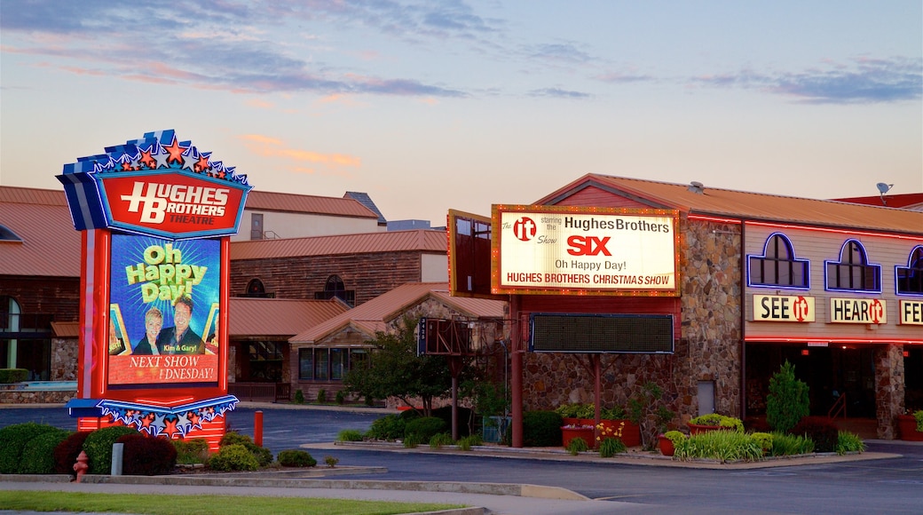 Hughes Brothers Theatre featuring signage and a sunset