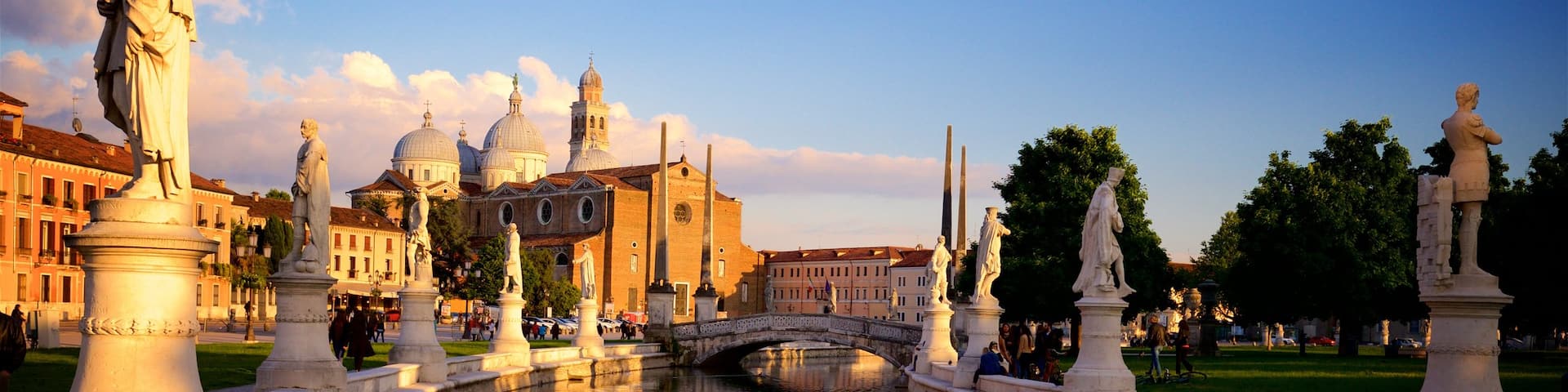 Prato della Valle showing a statue or sculpture, a sunset and a garden