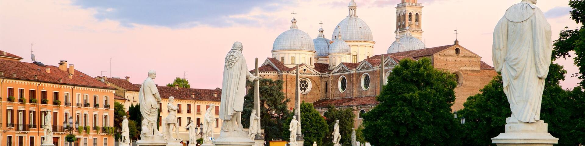 Prato della Valle featuring a river or creek, a statue or sculpture and a garden