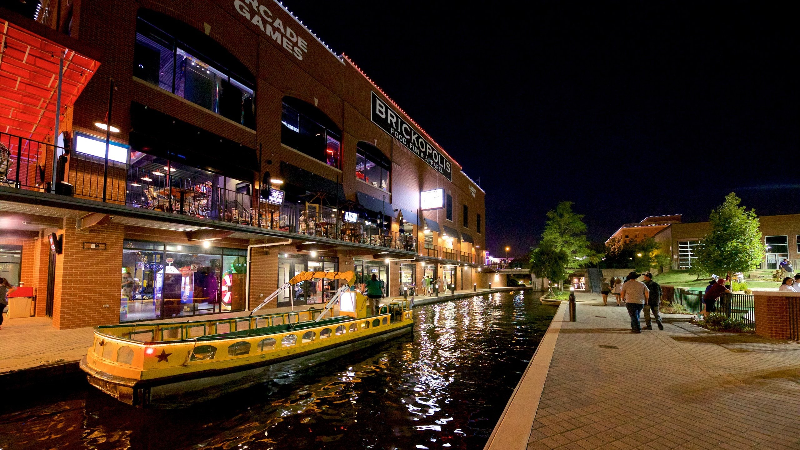 Bricktown showing a river or creek and night scenes