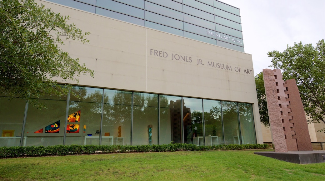 Fred Jones Jr. Museum of Art featuring signage, outdoor art and a garden