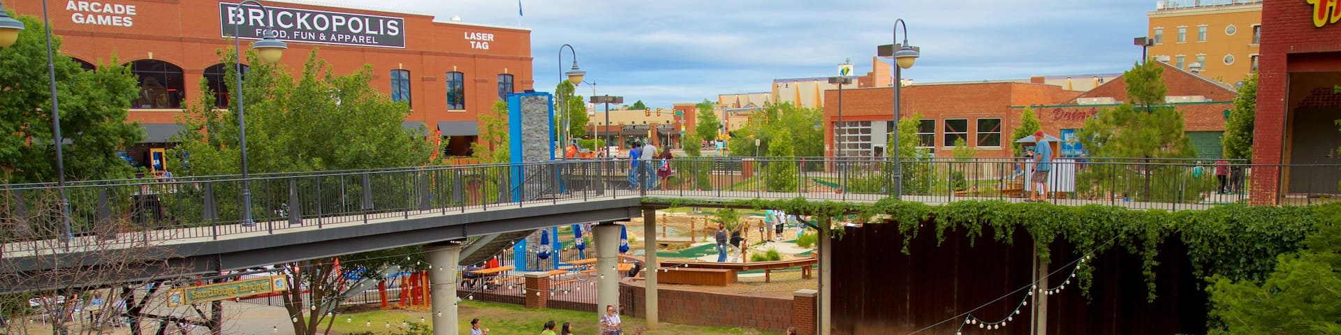 Bricktown featuring a river or creek, flowers and a bridge