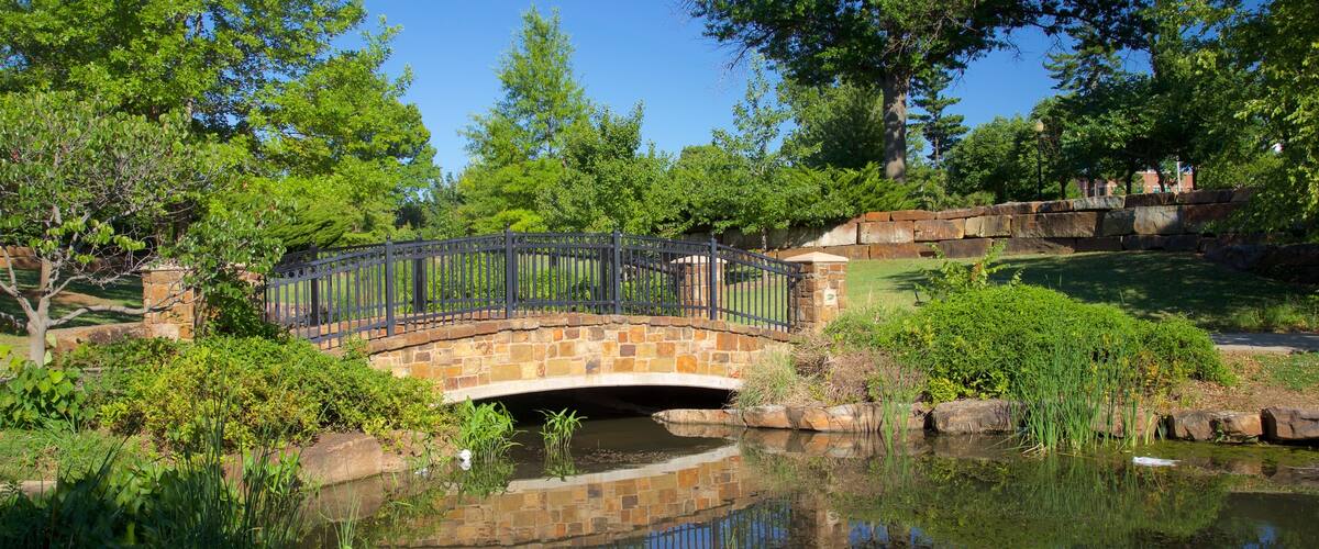 Centennial Park featuring a bridge, a park and a river or creek