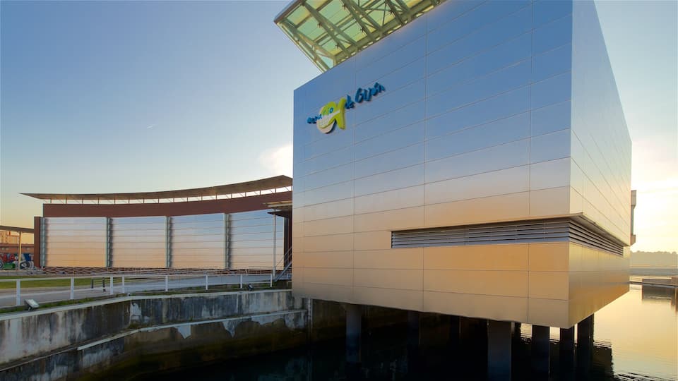 Aquarium of Gijon showing a sunset, modern architecture and signage