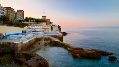 Gijon featuring general coastal views, a coastal town and a sunset