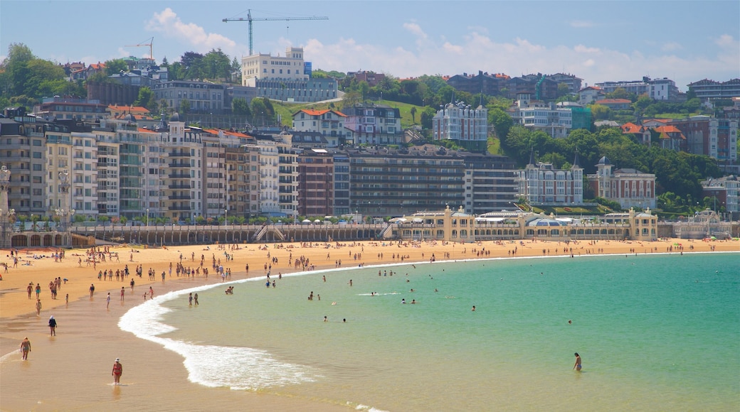 Concha Beach which includes general coastal views, swimming and a city