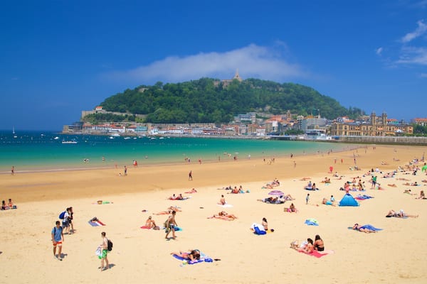 Concha Beach which includes general coastal views, a coastal town and a sandy beach