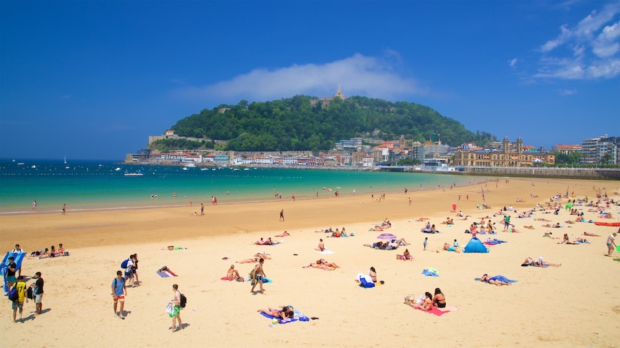 Concha Beach which includes general coastal views, a coastal town and a sandy beach