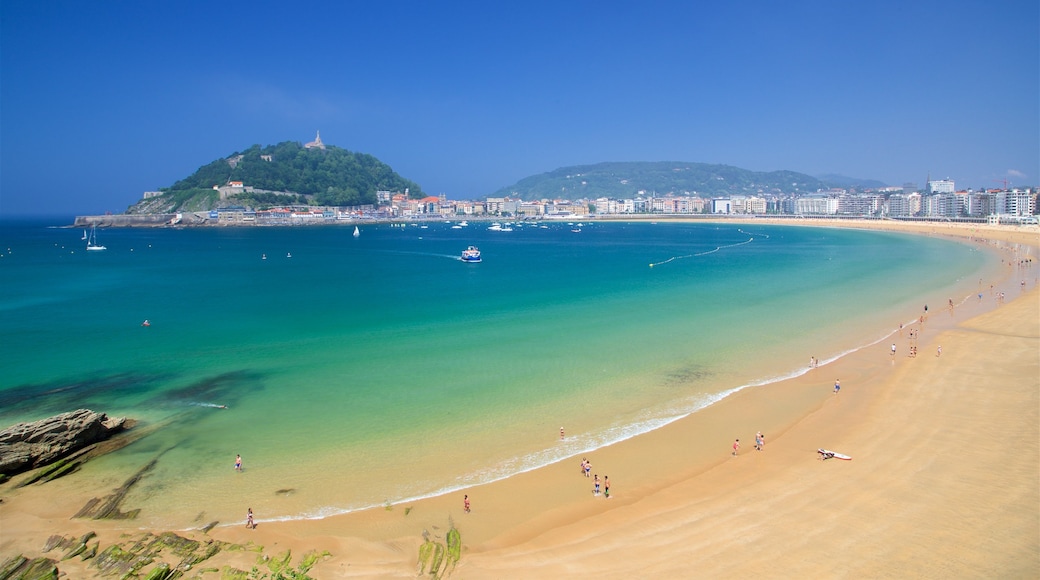 Concha Beach which includes a sandy beach, a coastal town and a bay or harbour