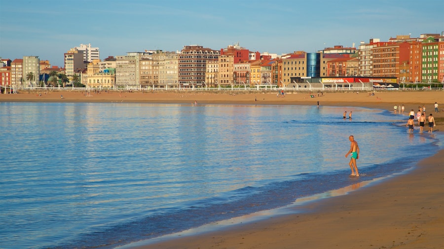 Playa de Poniente which includes swimming, a coastal town and a sandy beach